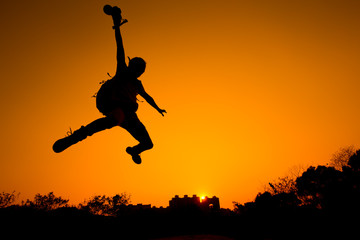 Obraz na płótnie Canvas Silhouette of Man jumping - color tone tuned