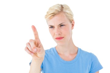 Serious blonde woman pointing with her finger
