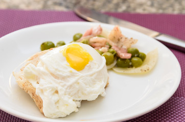 Poached Egg on toast serving stir fried sugar pea and bacon