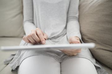 Fototapeta premium Women are reading e-books on the sofa