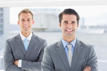 Two businessmen smiling at camera