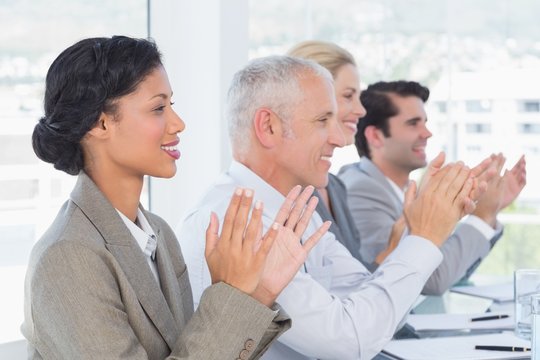 Business team applauding during conference