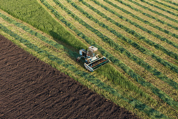 aerial view of harvest fields with combine