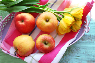 Beautiful bouquet of tulips with fruits on napkin close up
