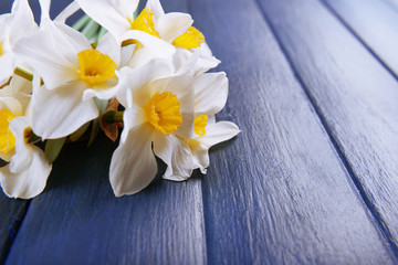 Beautiful bouquet of daffodils on wooden background