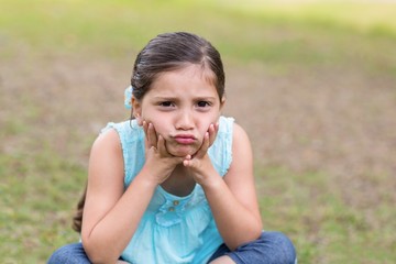 Fototapeta premium Little boy feeling sad in the park