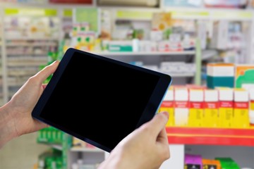 Composite image of hands holding tablet