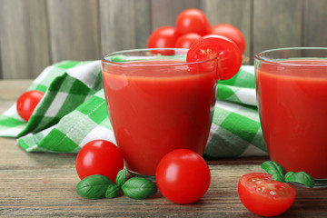 Glasses of tomato juice with vegetables on table close up