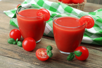 Glasses of tomato juice with vegetables on table close up