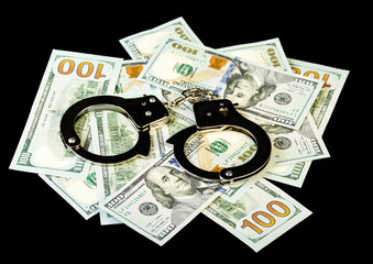 Handcuffs on dollar bills