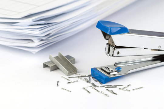 stapler and pile of papers.