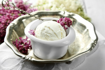 Beautiful composition with tasty ice cream and lilac flowers