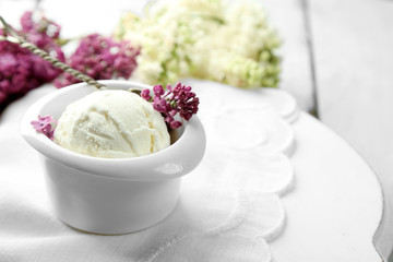 Obraz na płótnie Canvas Beautiful composition with tasty ice cream and lilac flowers