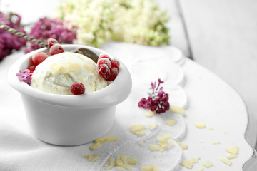 Beautiful composition with tasty ice cream and lilac flowers