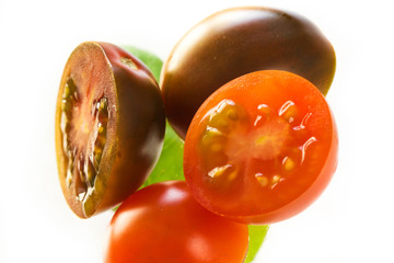Tomatoes and basil leaves isolated on white