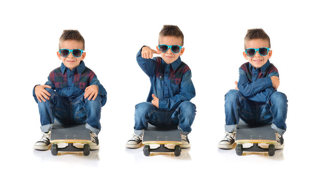 Kid playing with skate board with thumb up