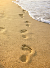 Fototapeta na wymiar Footmarks on the sandy beach