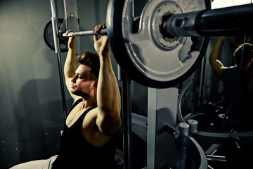 Fototapeta na wymiar strong bodybuilder athlete with heavy weights in gym