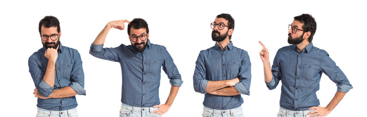 Young hipster man thinking over white background