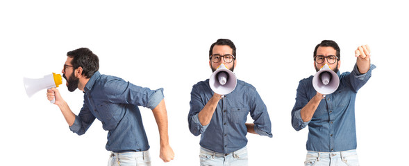Young hipster man shouting by megaphone