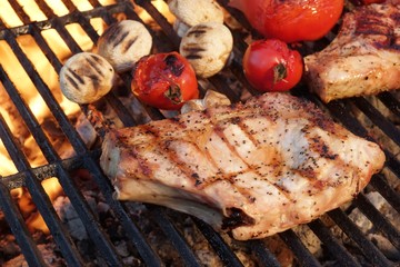 Pork Rib Steaks, Tomato And Mushrooms On Hot BBQ Grill