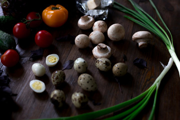 salad preparation quail eggs, mushrooms, brie, olives rustic