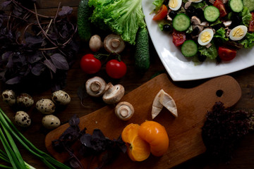 Fototapeta na wymiar salad preparation quail eggs, mushrooms, brie, olives rustic