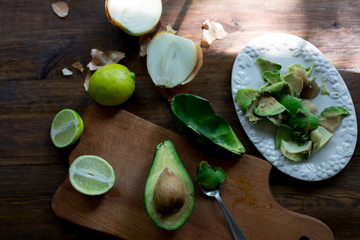 Fototapeta na wymiar preparation guacamole ingridients on table lime, onion, avocado