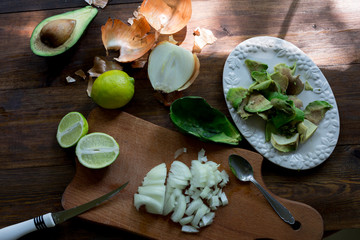 preparation guacamole ingridients on table lime, onion, avocado