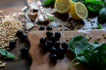 pesto preparation ingredients basil, garlic, lemon, pine, olives