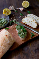 pesto preparation ingredients basil, garlic, lemon, pine, olives