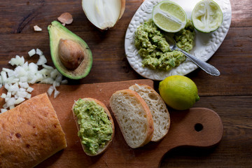 preparation guacamole ingridients on table lime, onion, avocado