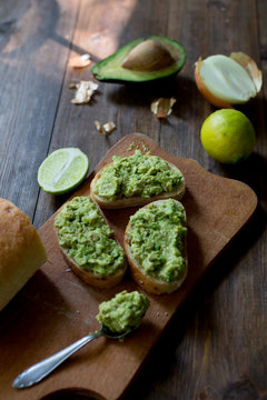 preparation guacamole ingridients on table lime, onion, avocado