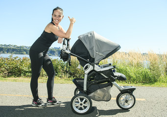 A Young mother jogging with a baby on the buggy