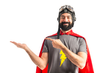 Superhero holding something