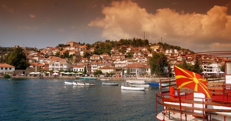 Lake Ohrid  and city of Ohrid, Macedonia, flag of Macedonia on tourist boat - obrazy, fototapety, plakaty