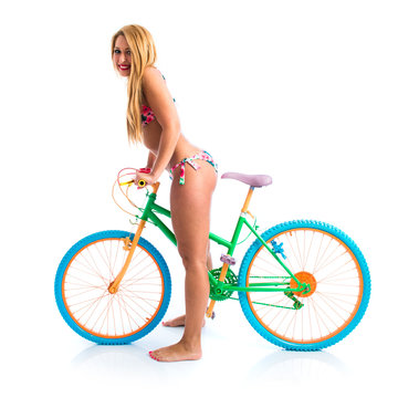 Happy girl in bikini with colorful bike
