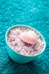 Spa setting with bath salt  and bath accessories on blue towel