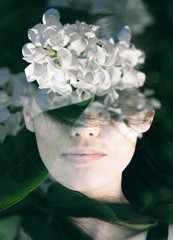 Dream like double exposure portrait of young woman
