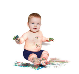 portrait of baby playing with bright colors, getting messy 