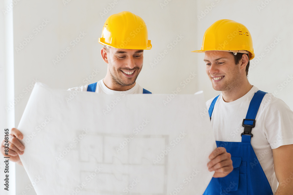 Wall mural group of builders with blueprint