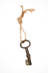 Old key on a rope on a white background