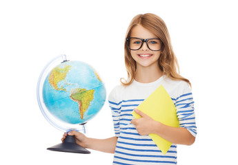 smiling child with globe, notebook and eyeglasses
