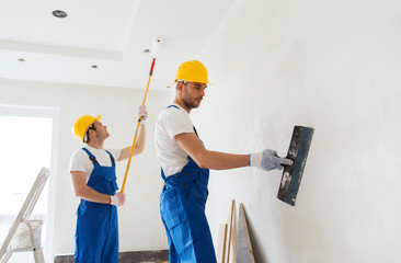 group of builders with tools indoors