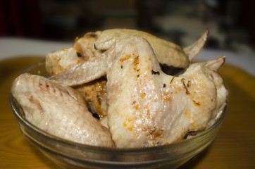 Cooked chicken wings coated with spices and ketchup
