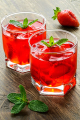 Cold strawberries drinks with strawberry slices and mint