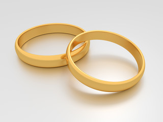 Wedding gold rings lie on each other