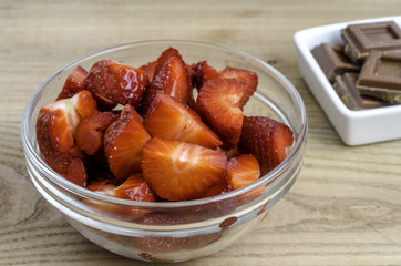 Strawberries in a glass bowl with chocolate.
