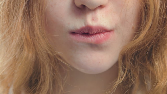 Natural lips of a girl with hair and freckles June.
