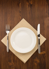 plate, knife and fork  on wood